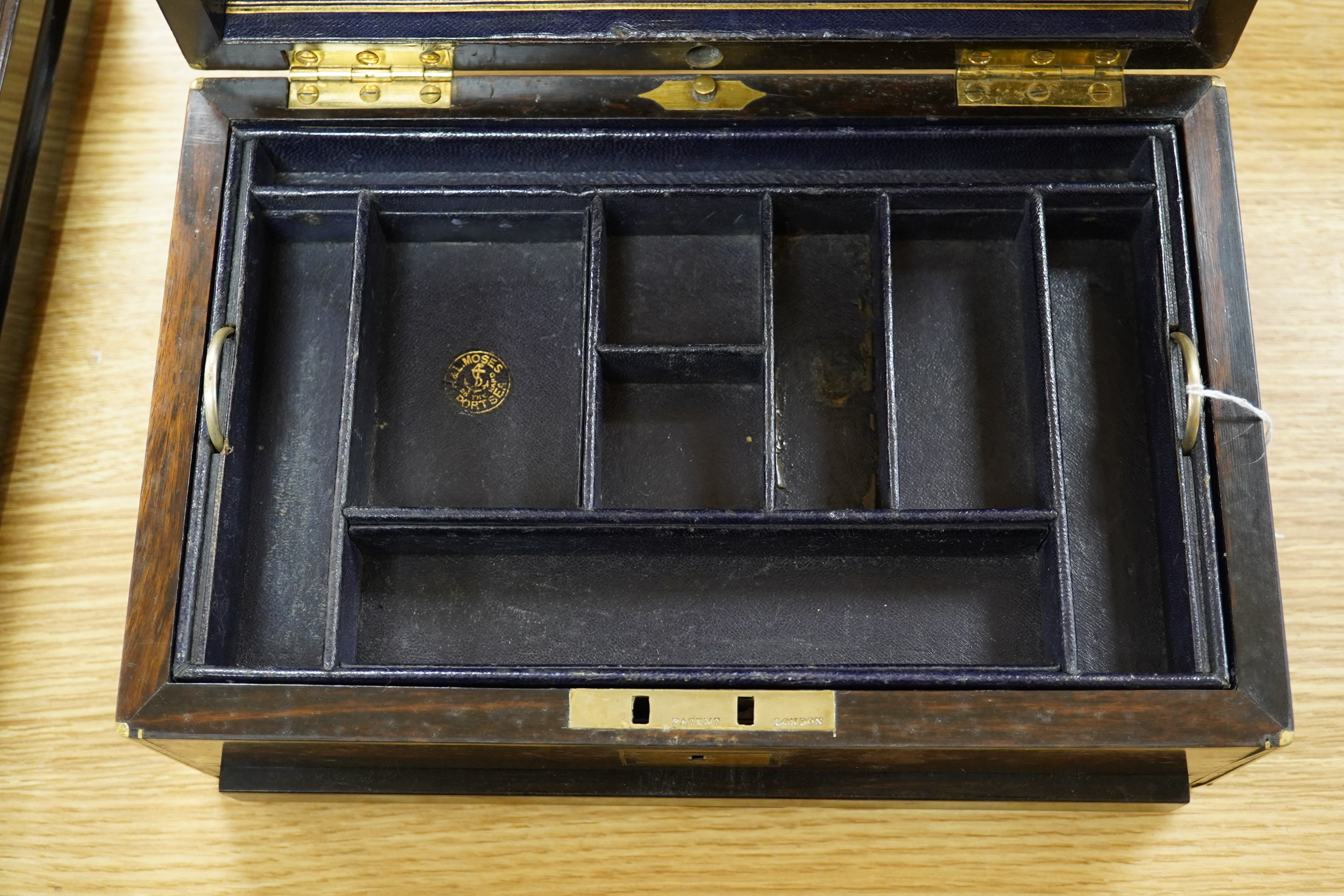 A Victorian brass bound coromandel wood jewellery casket, with velvet lined lid, a fitted leather and velvet top compartment shelf and base lower drawer. 13cm high x 28cm wide. Condition - some splits to the veneer on th